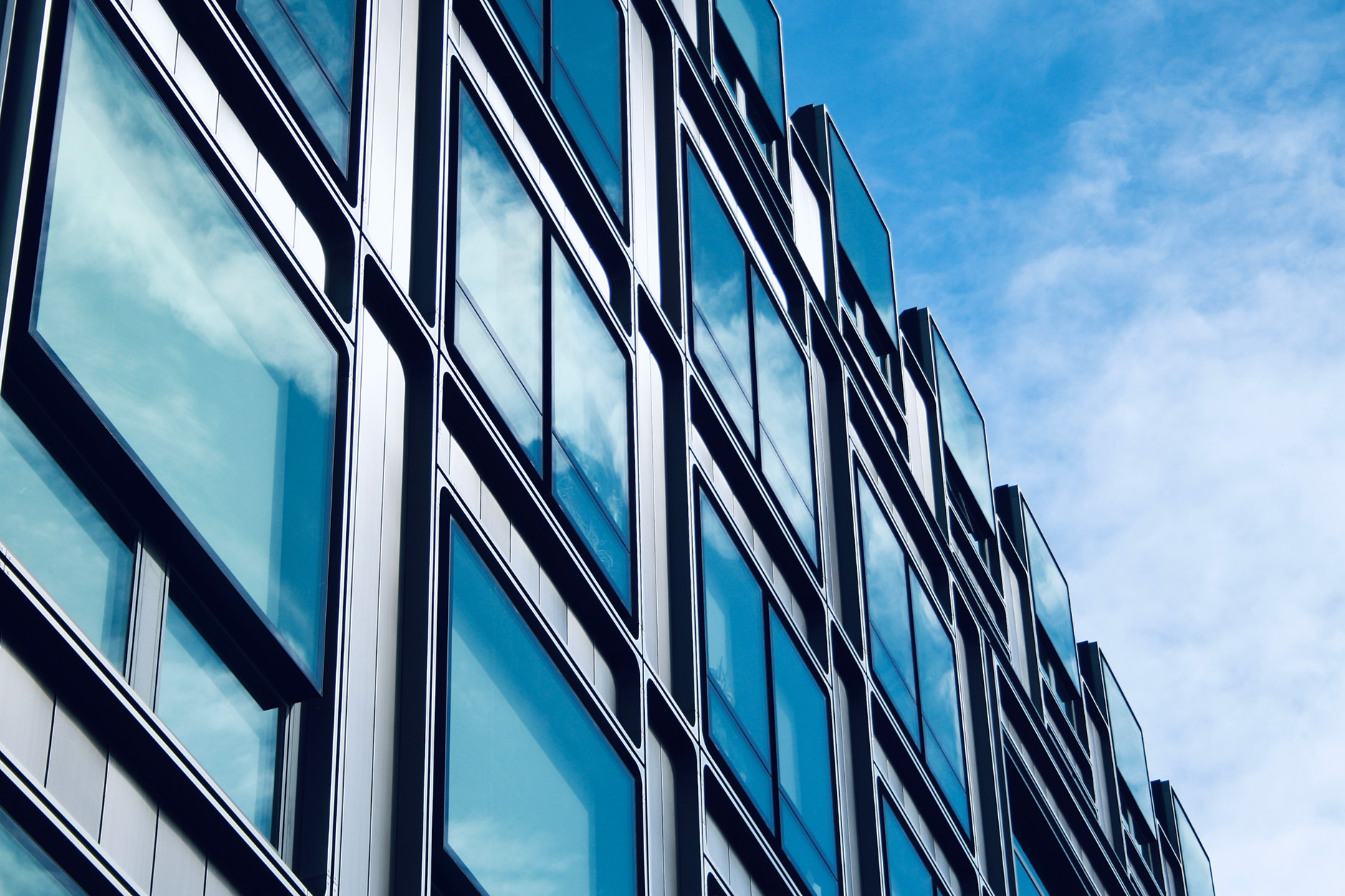 Two curved towers against blue sky