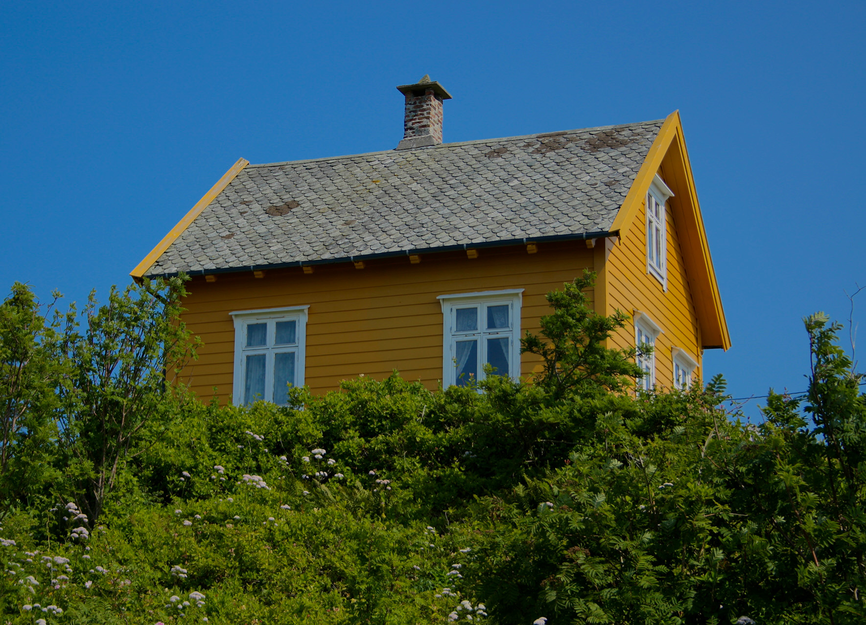 Lone red cabin on a hillside